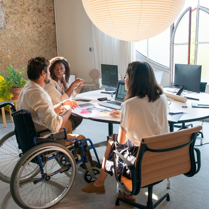People discussing work activities around a table
