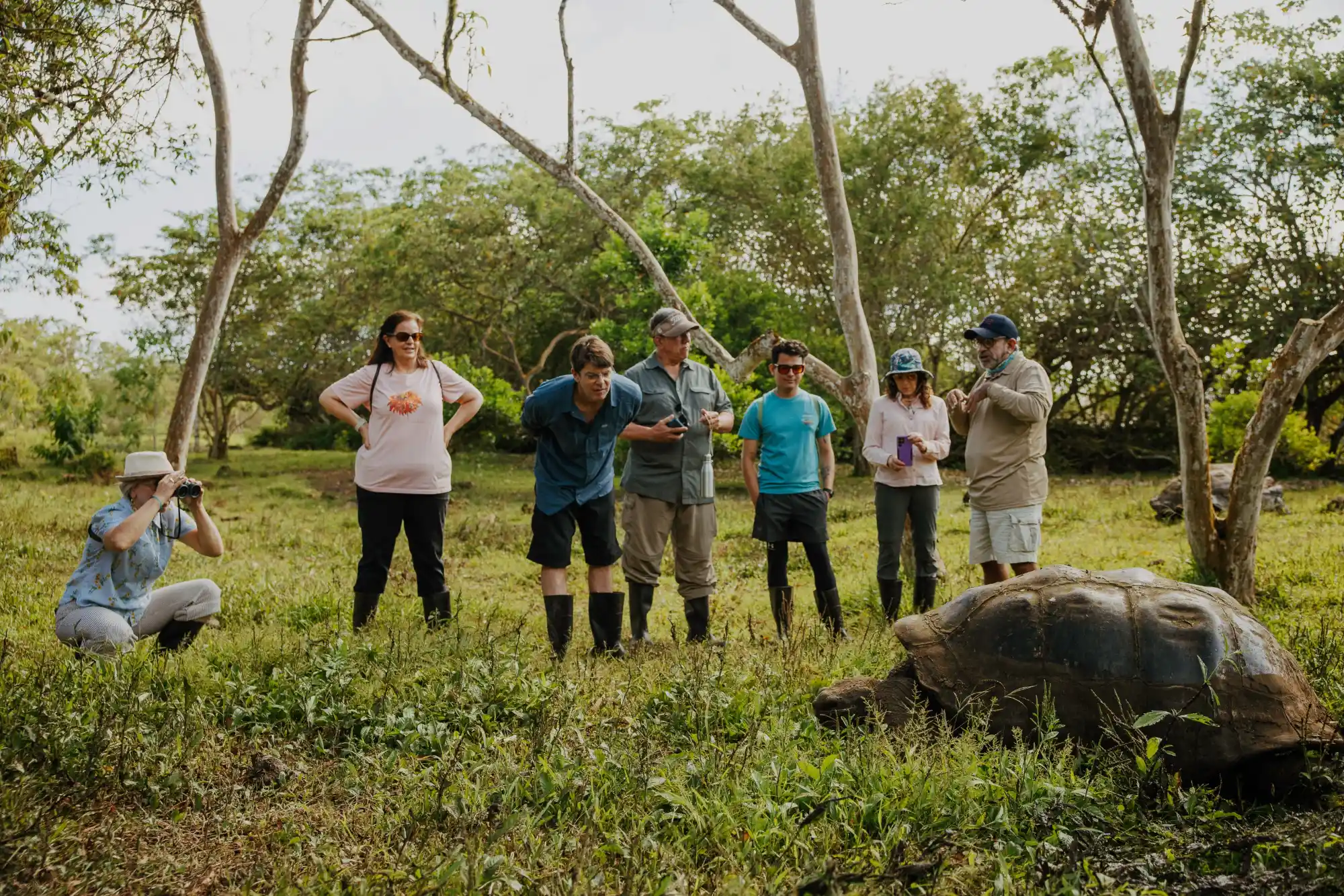 Naturalist guide leading a shore excursion through a remote Galápagos landscape