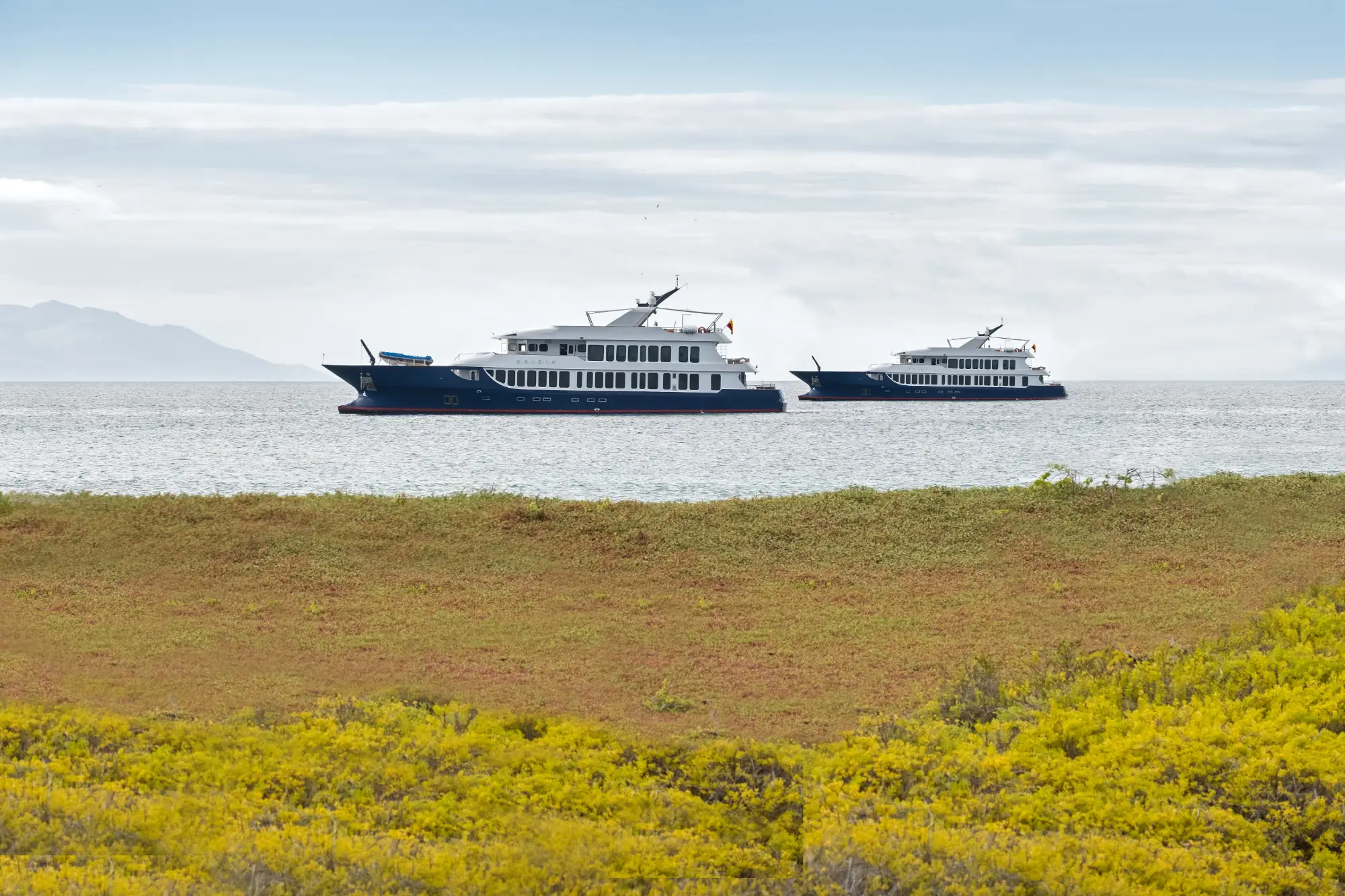 Origin and Theory expedition sister ships at anchor in the Galápagos
