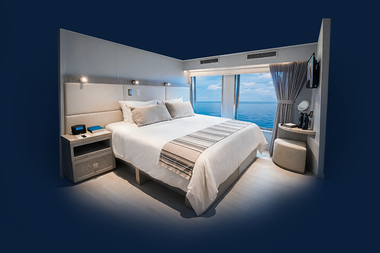 Stateroom with a king bed and panoramic ocean-view window
