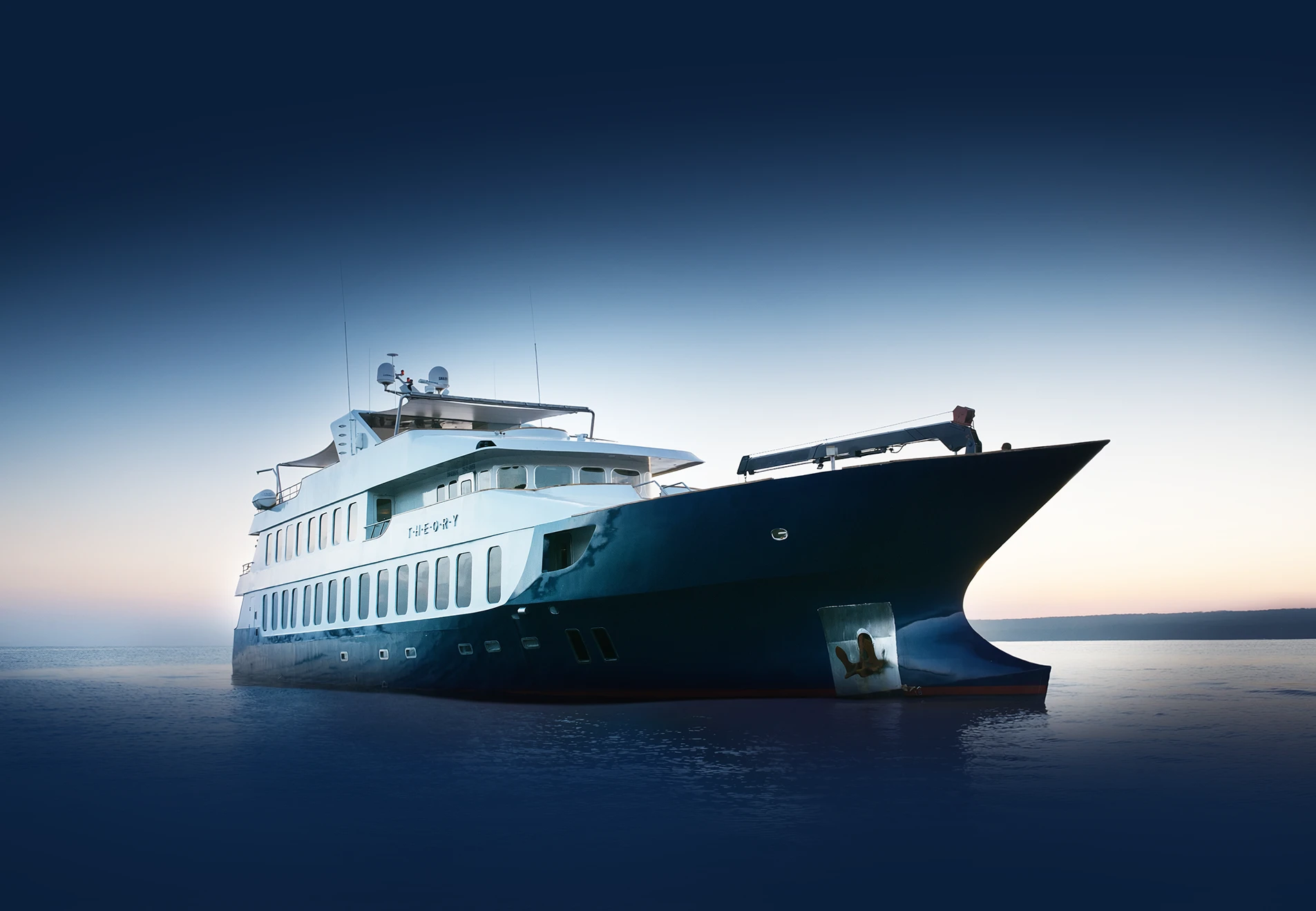 Theory at anchor at dusk, showing its dark wave-piercing bow