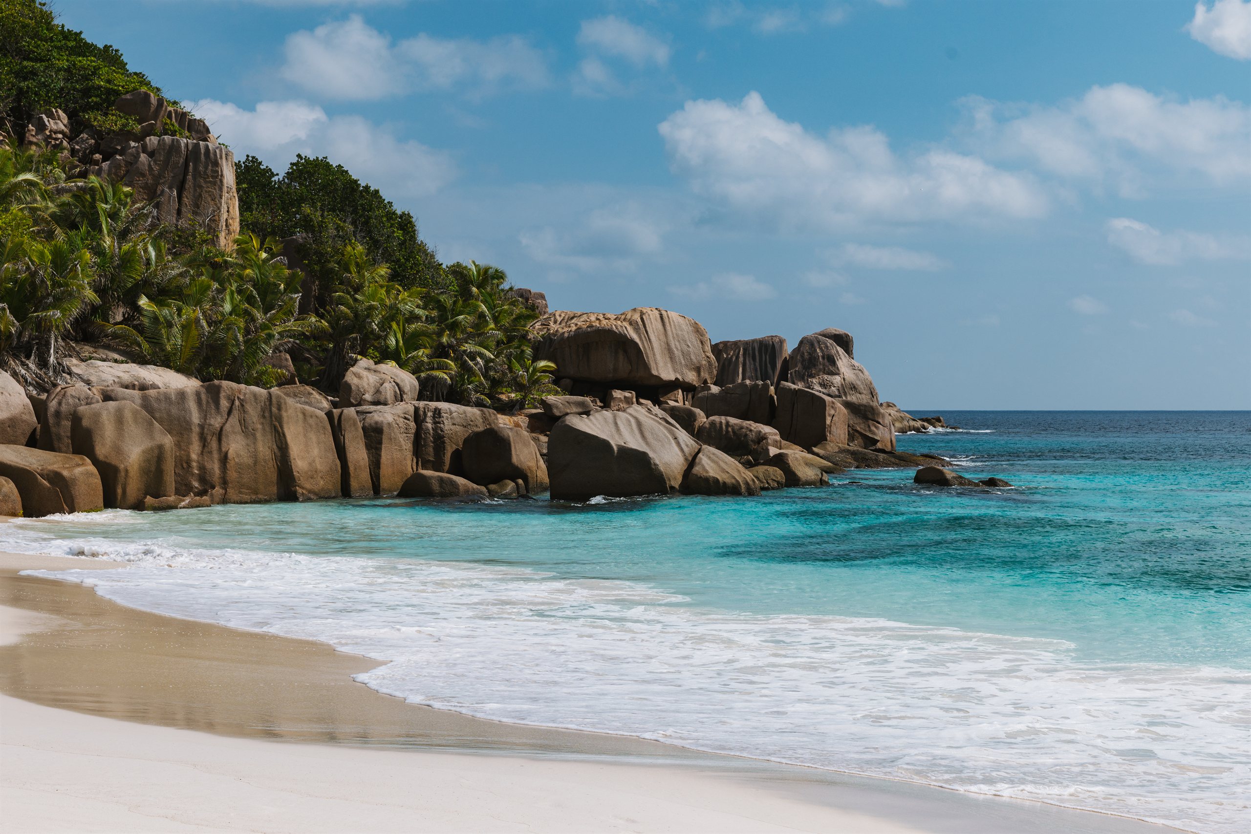 Granite boulders framing a white-sand beach in the Seychelles inner islands