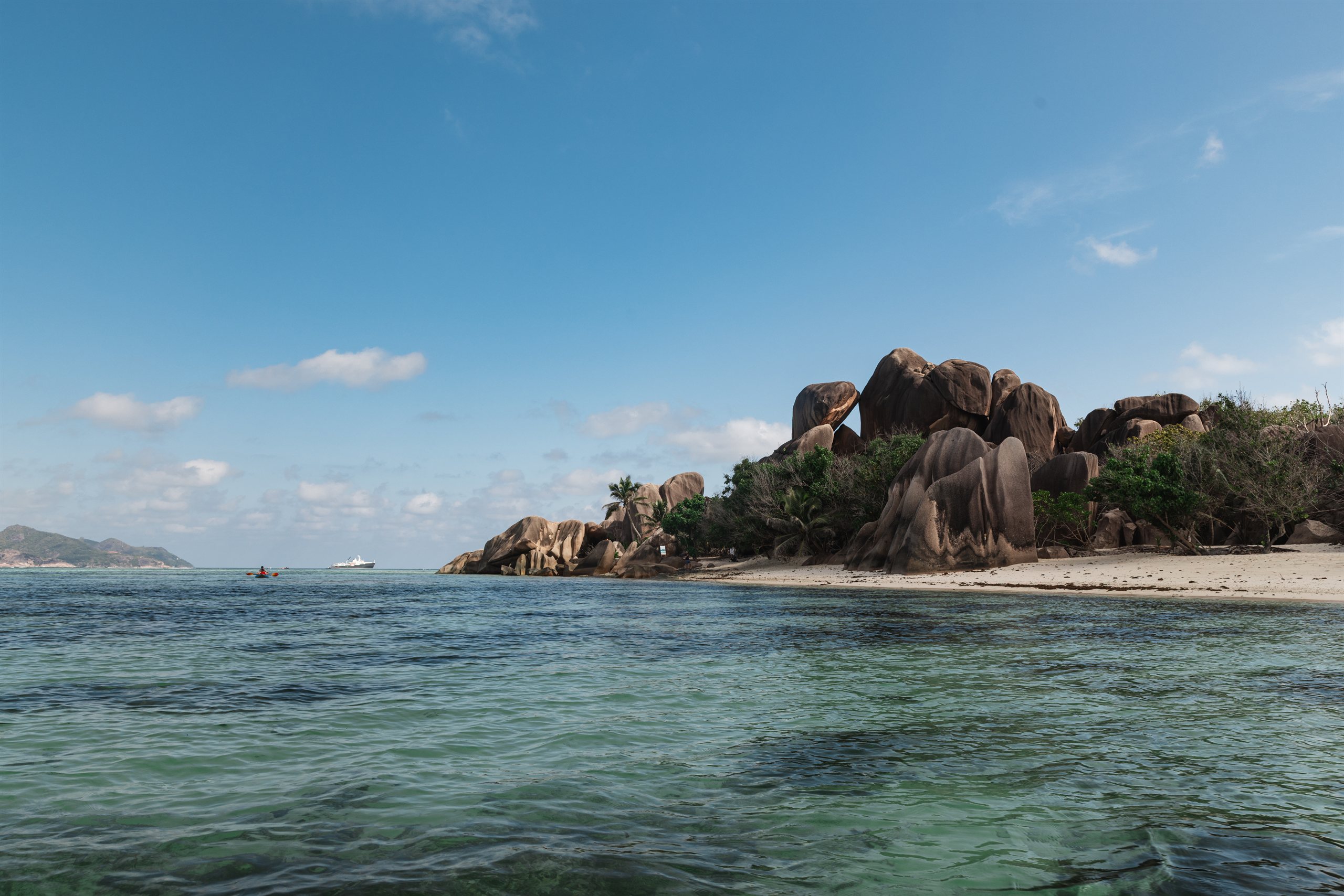 Granite boulders rising above a La Digue beach