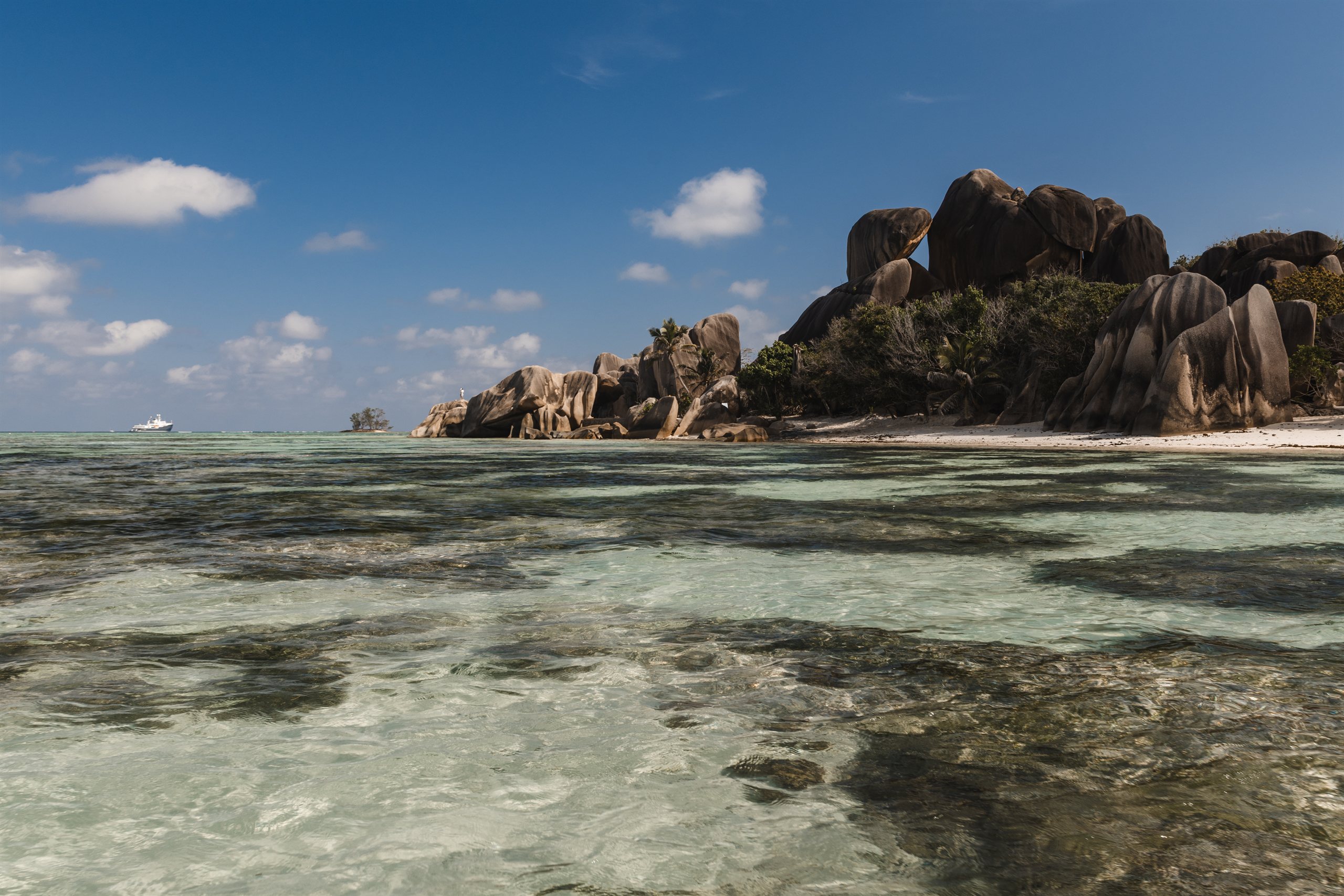 Shallow lagoon and granite boulders on La Digue