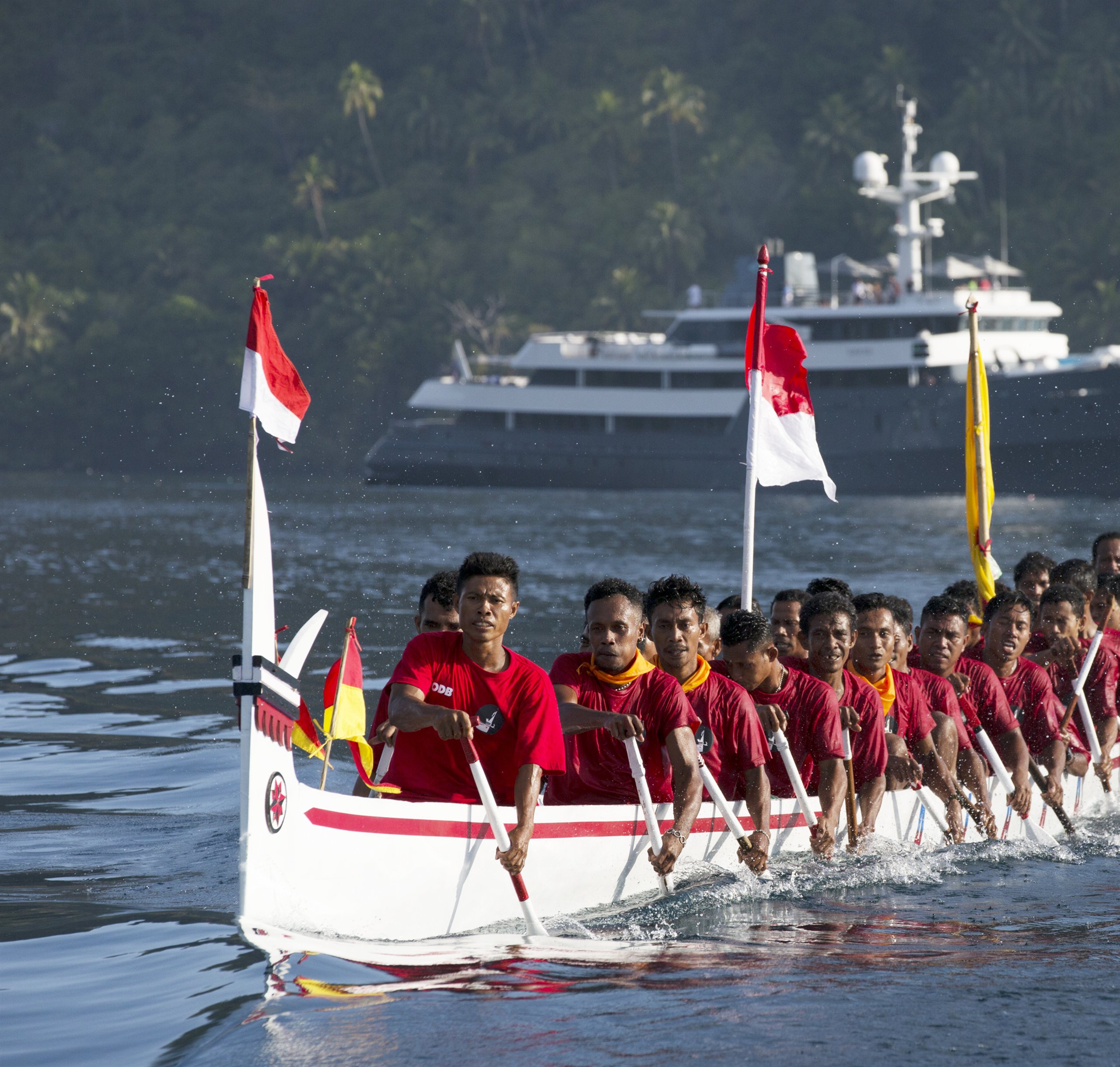 Aqua Blu at anchor with a traditional kora-kora canoe alongside