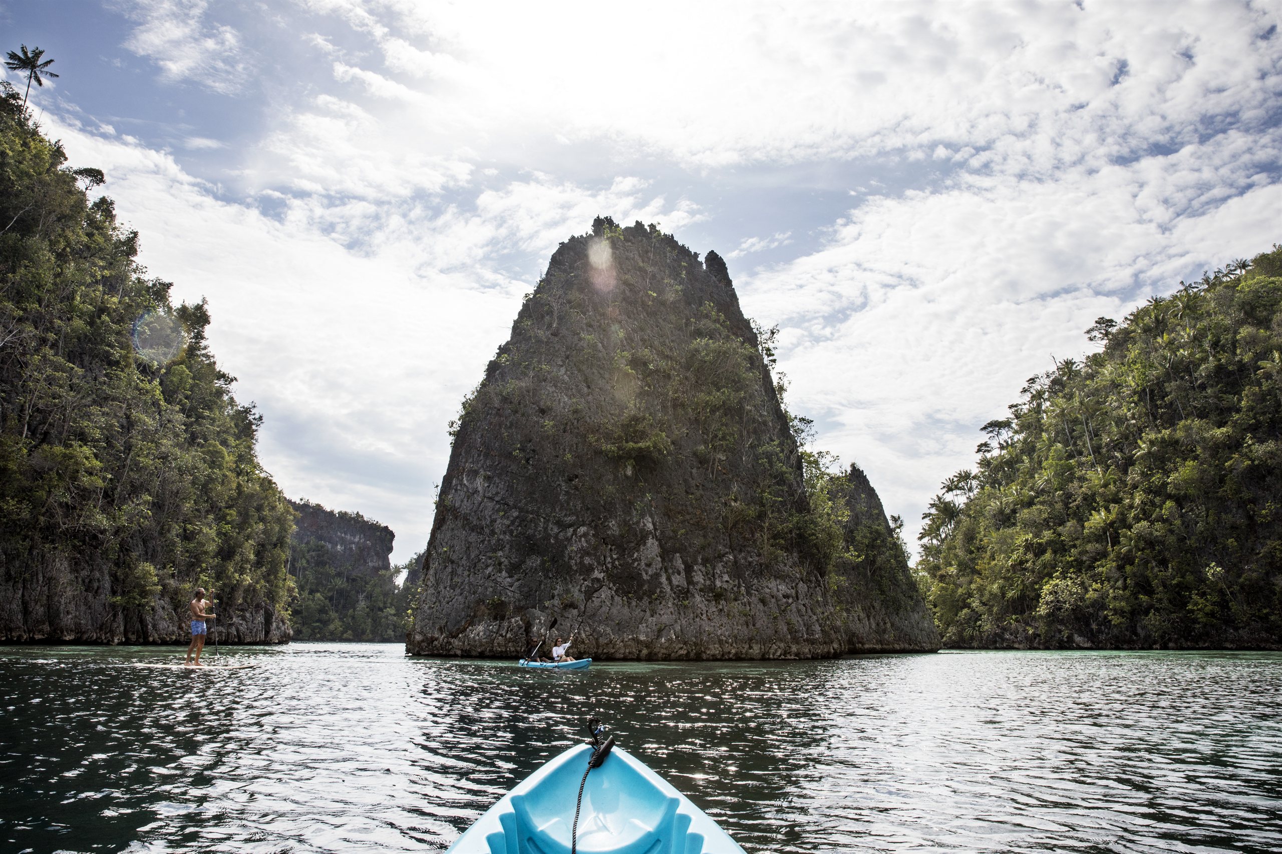 Kayaking beneath limestone cliffs in Kabui Bay