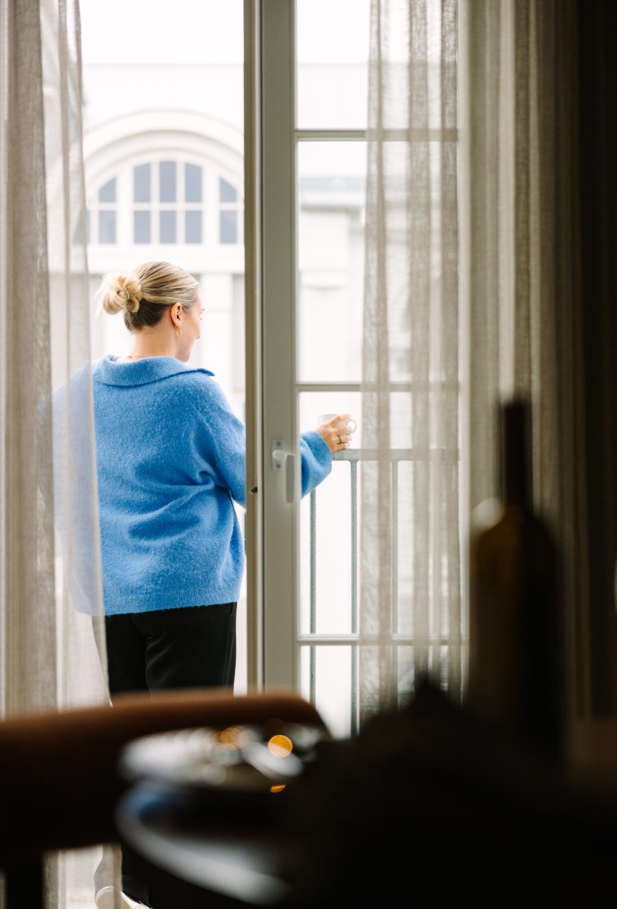 Guest by the open balcony door