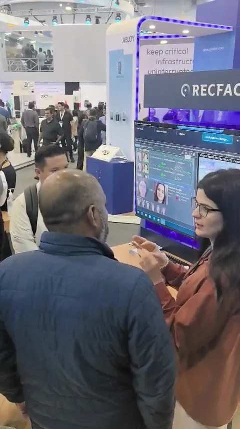 A RecFaces team member runs a demo for visitors on the Milestone stand