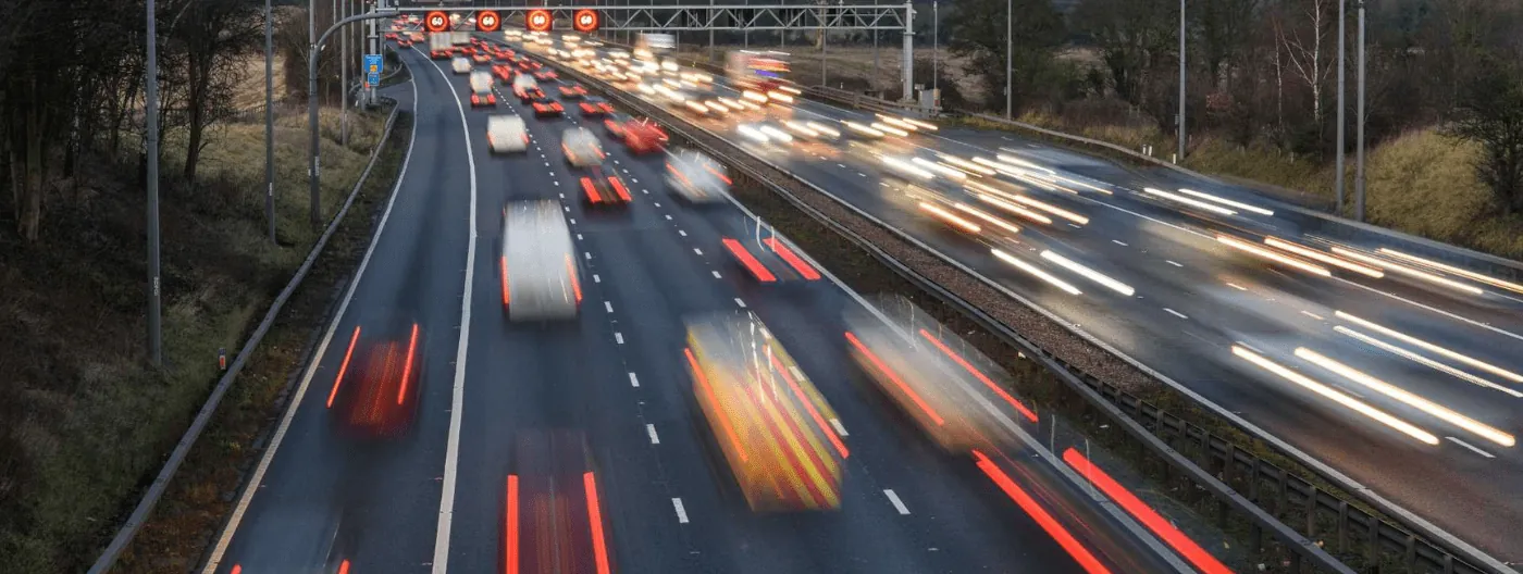 Cars zooming across a busy UK motorway
