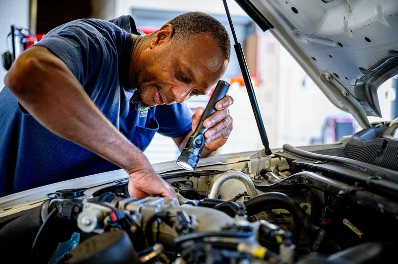 mechanics checking a car during an MOT test