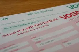 MOT tester checking car during an MOT test