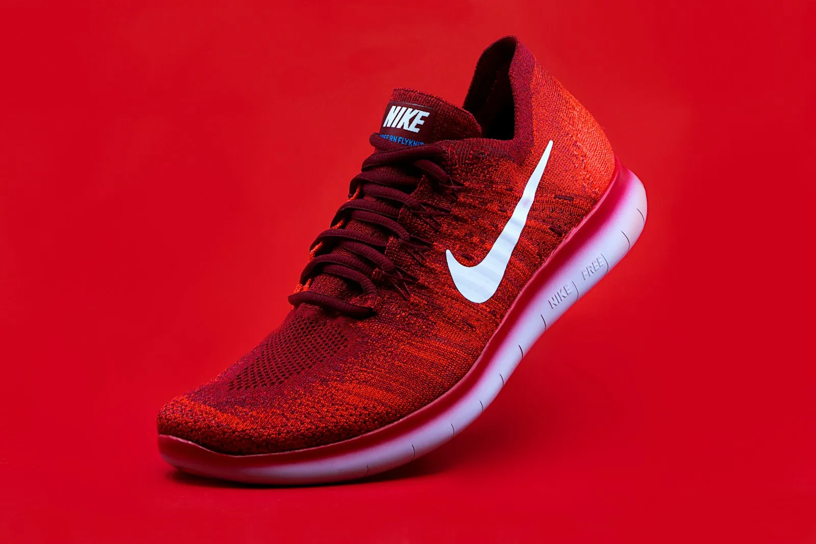 Red sneaker on a red background