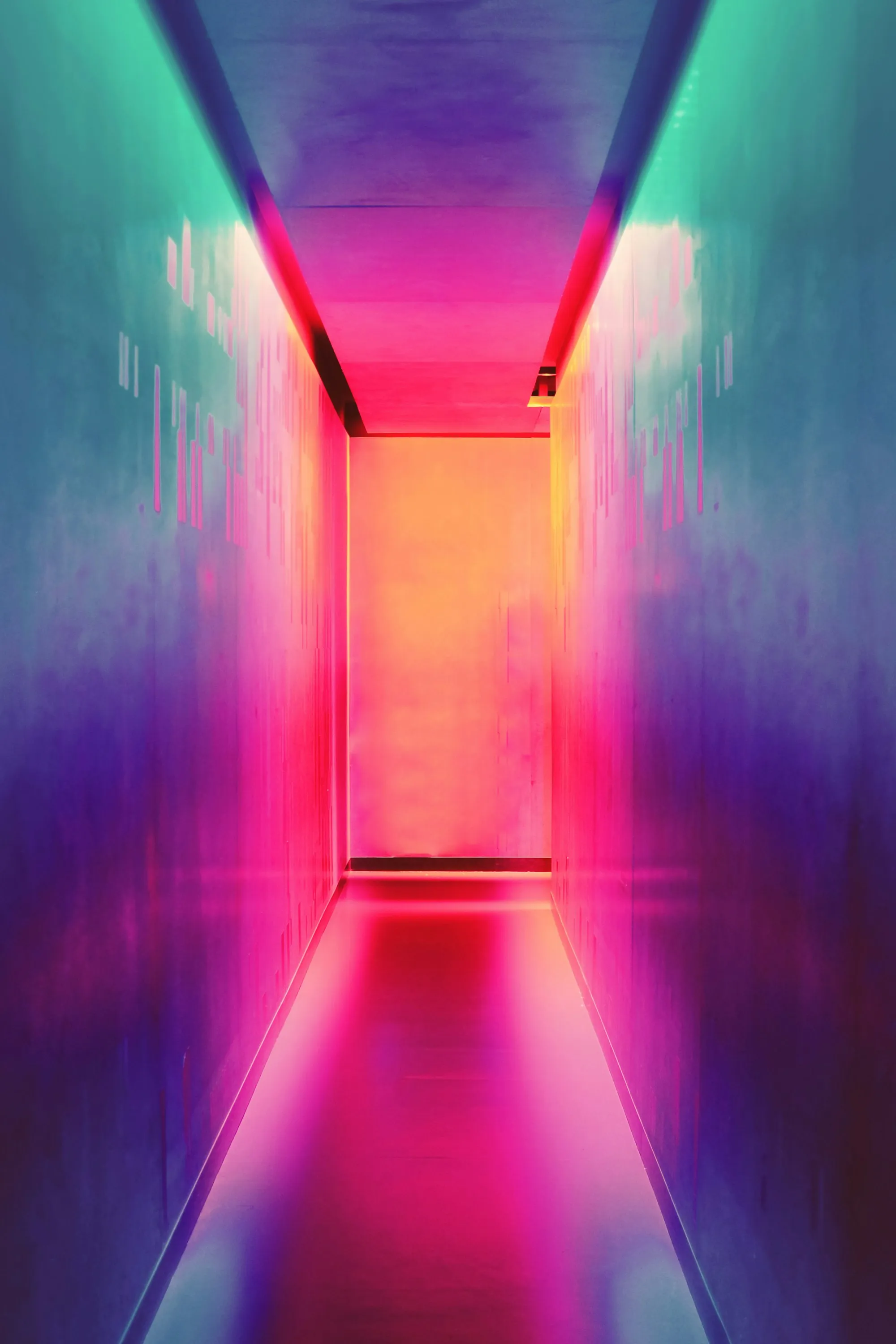 Corridor glowing with pink, purple and teal neon light
