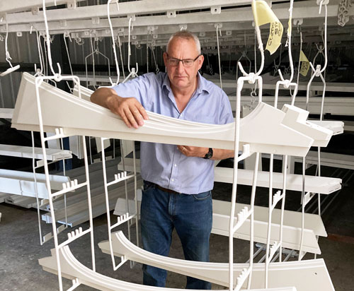 Kevin Tuck, Managing Director of Tuck's Wood Roof Lanterns, making an inspection in the factory's paintshop in Norfolk, UK
