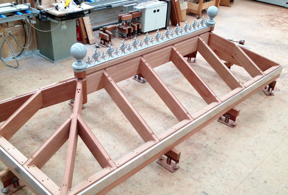 Fleur-de-lis ridge cresting and ball finials on a lantern in the workshop