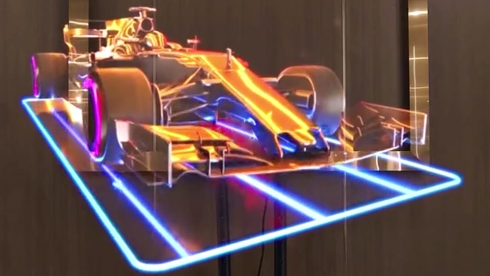HOLOFAN MAX showing a 3D race car hologram in a lobby