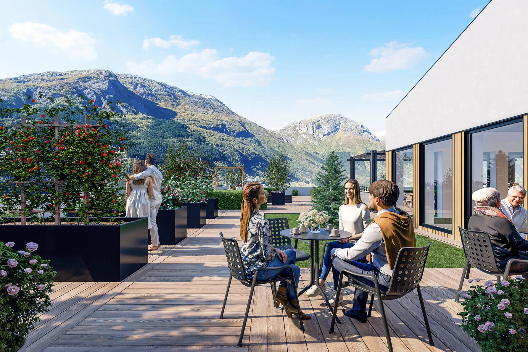 Sosial takterrasse med sittegrupper, blomsterkasser og panoramautsikt mot fjellene. Et felles møtested for beboerne i Domus Gaarden.