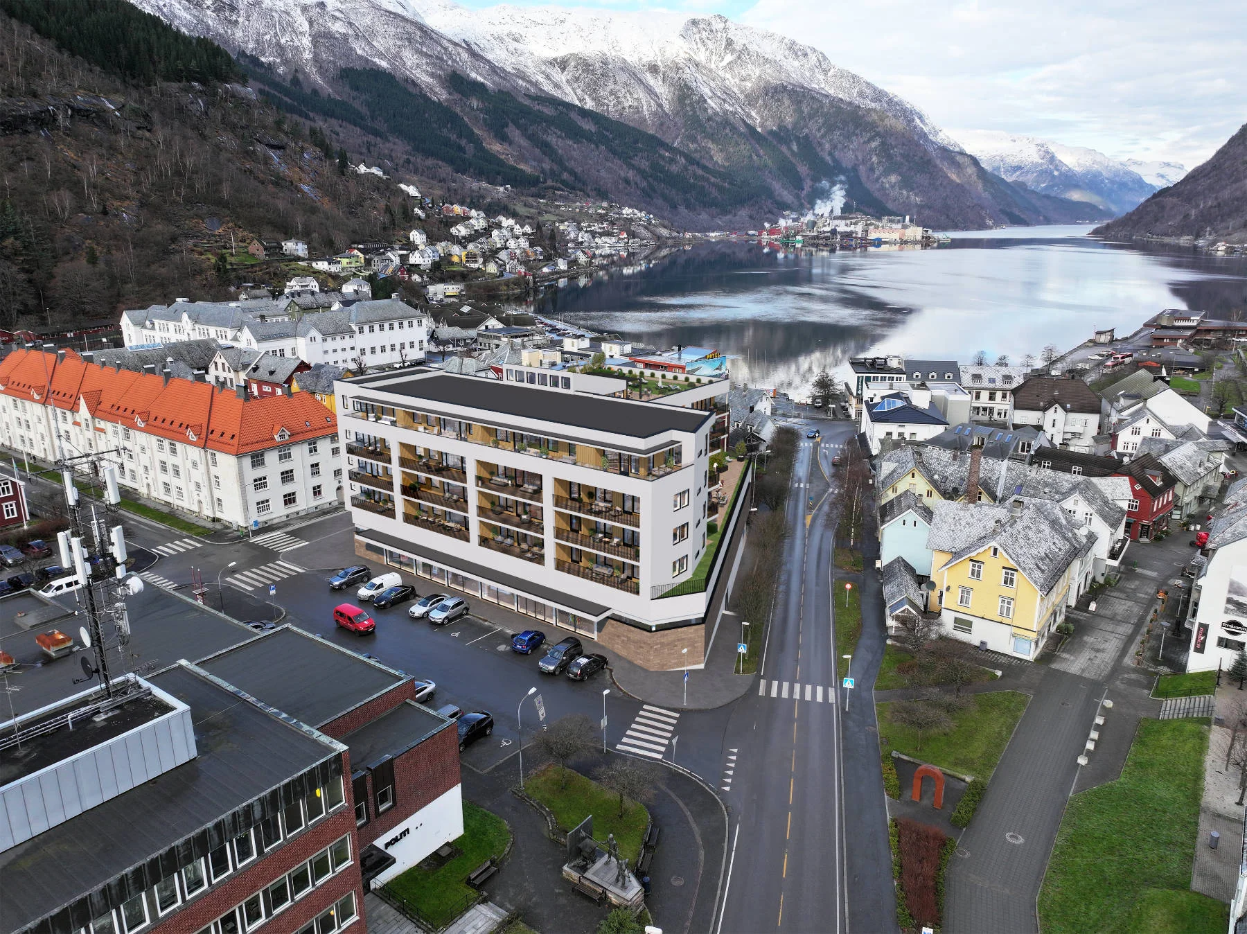 Domus Gaarden sett fra lufta, med fjorden og snødekte fjell i bakgrunnen. En sentral beliggenhet med natur rett utenfor døren.