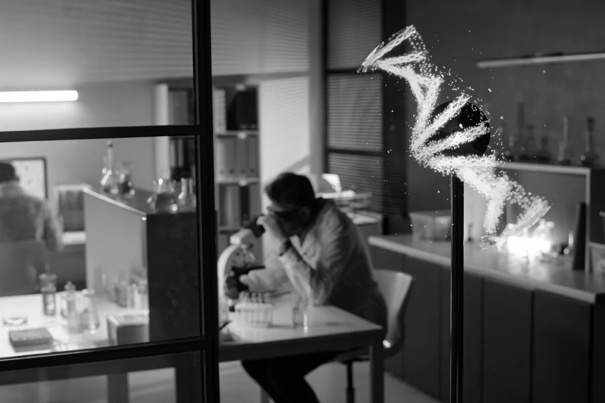 Scientists working with a microscope and DNA model