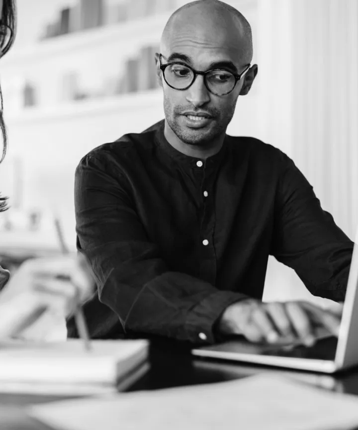 Professional reviewing information on a laptop