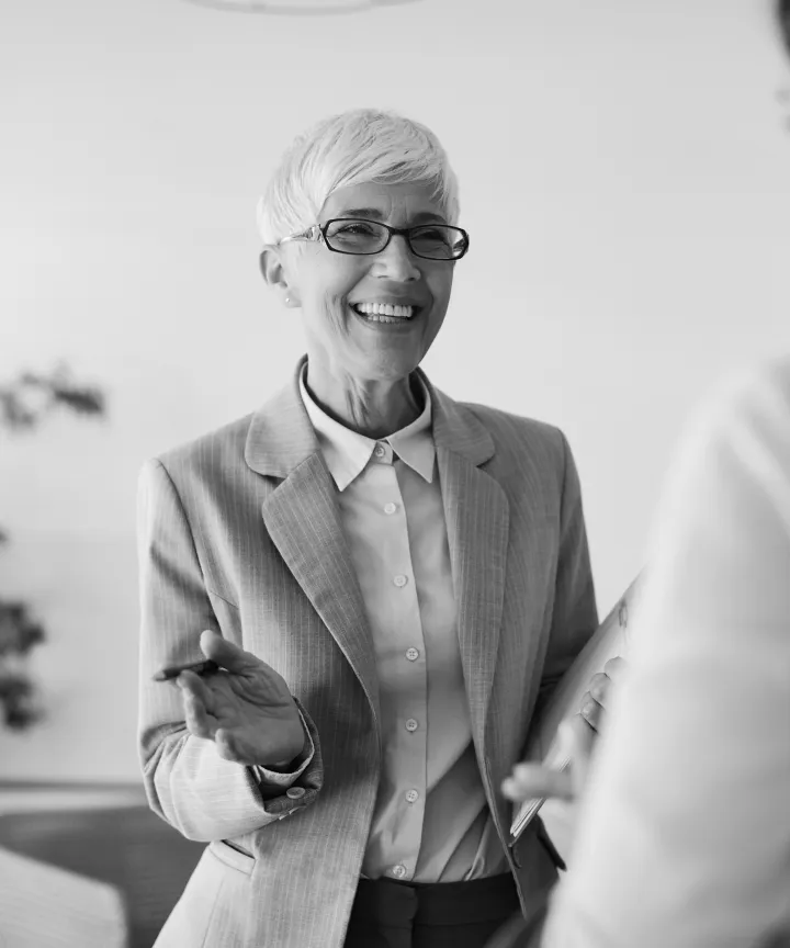 Smiling professional woman holding a clipboard