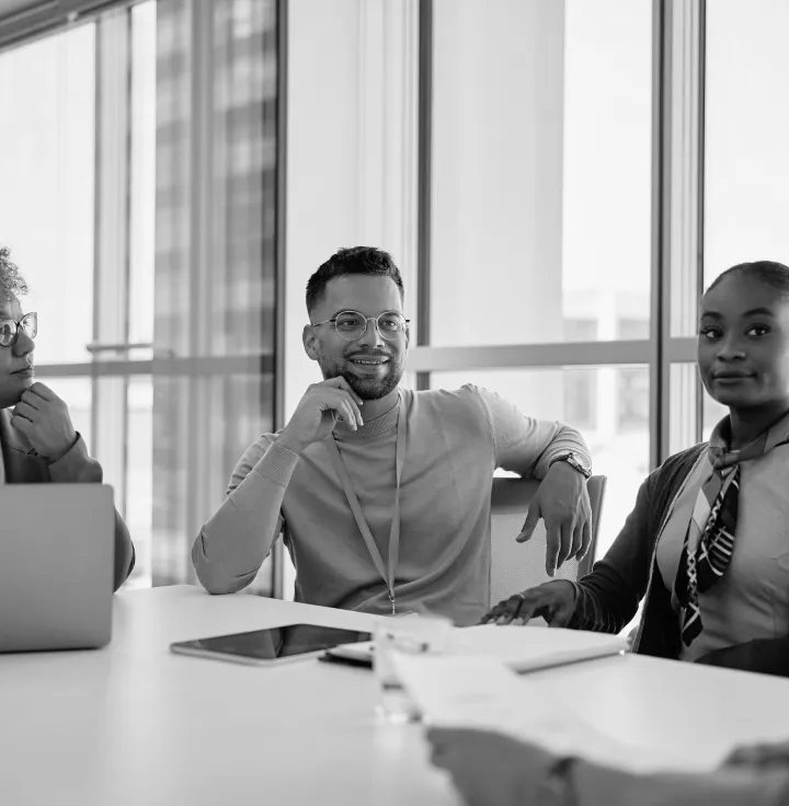 Colleagues seated around a conference table