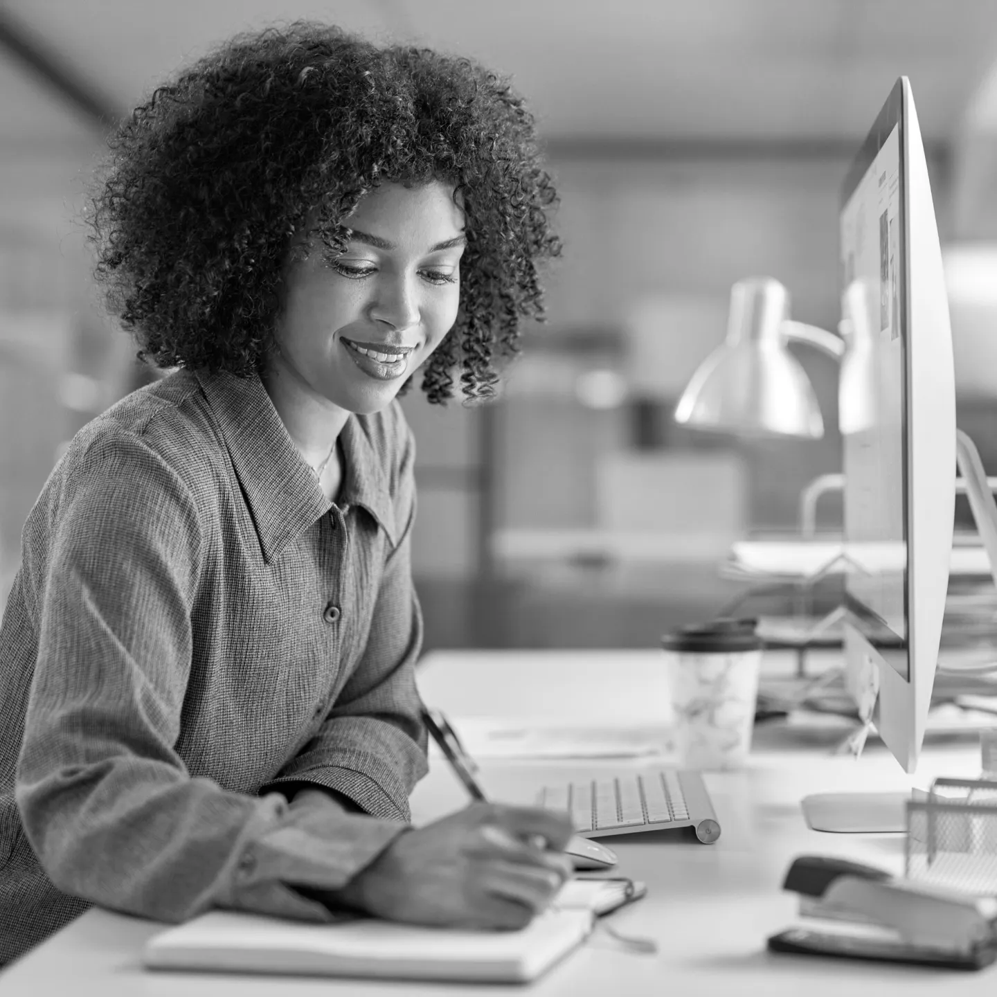 Benefits analyst reviewing claims data at her desk