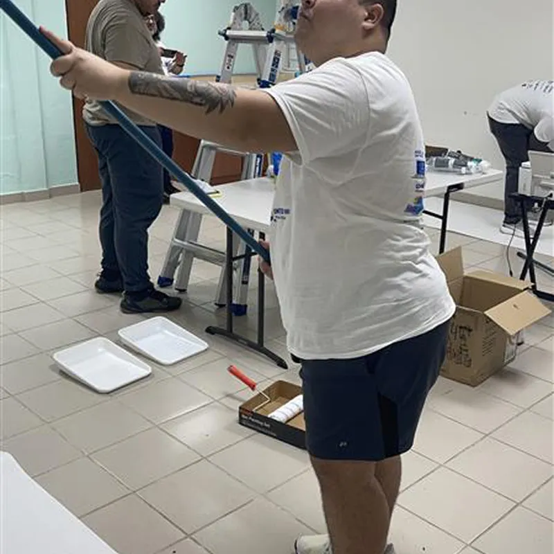 Volunteer preparing a room for painting