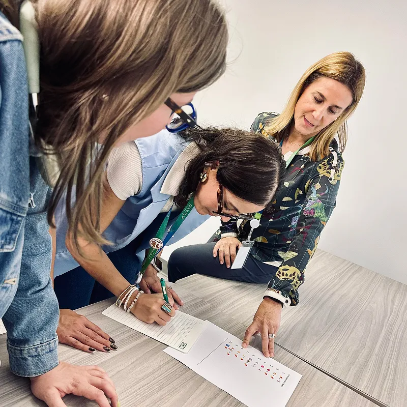 Employees completing a team activity worksheet