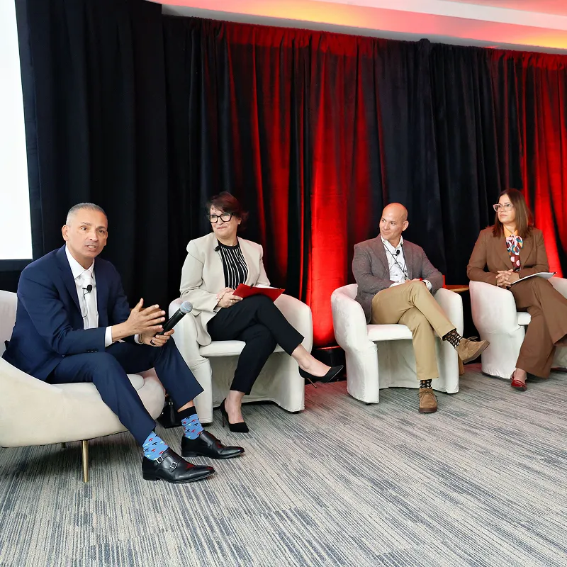 Speakers participating in a healthcare conference panel