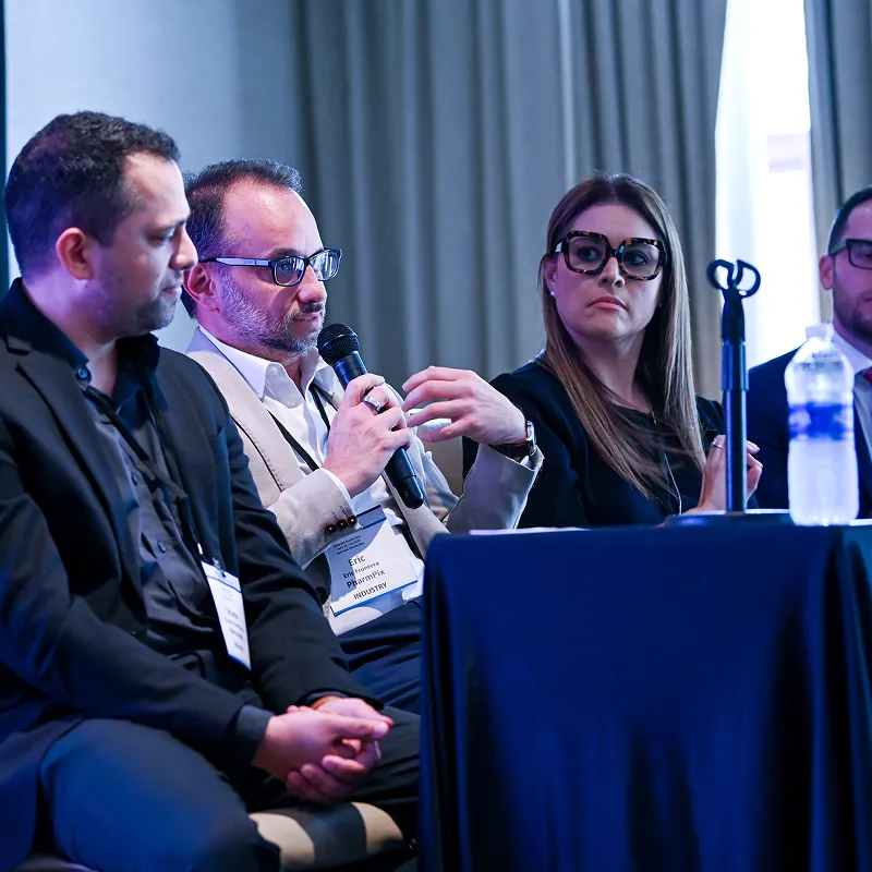 Speakers participating in a conference panel