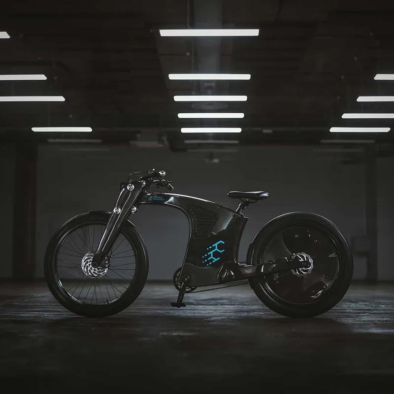 Sleek black electric motorcycle with a futuristic design, featuring a spoked front wheel, a solid rear wheel, and blue illuminated logo on the side, set against a dimly lit indoor background with ceiling lights.