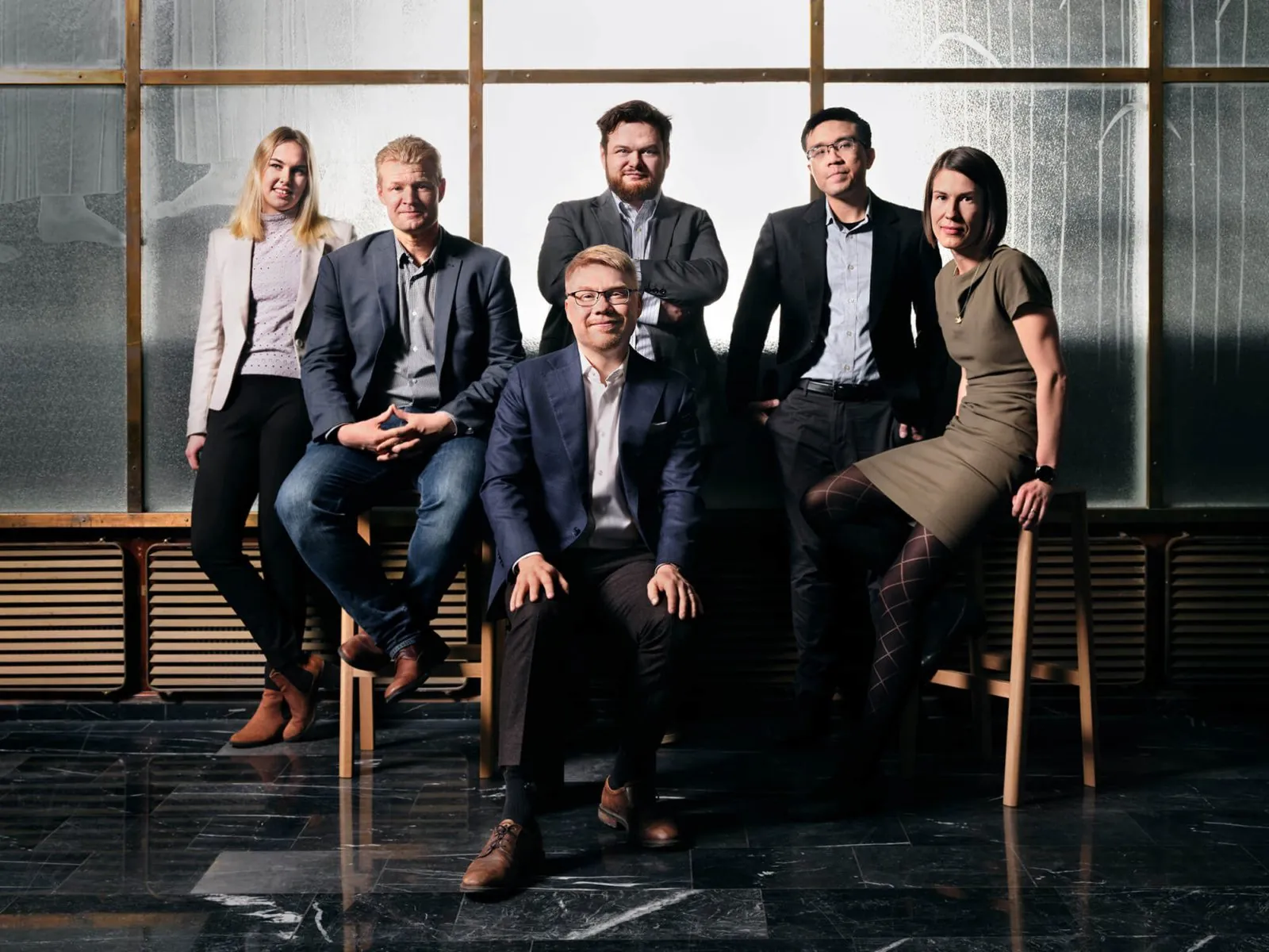 The SuperGround team, six people posing in a sunlit office