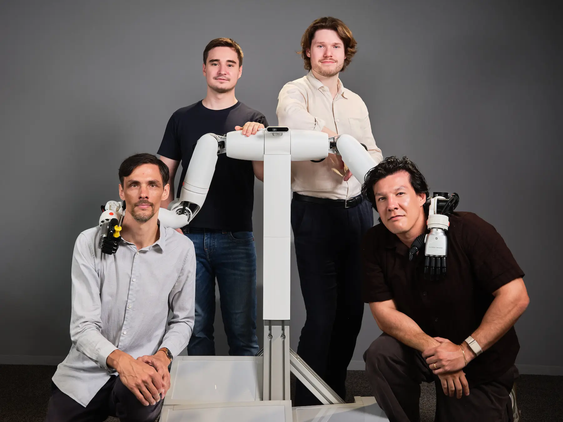 Founding team at O-ID poses with a robot