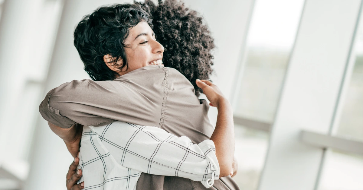 Two people embracing indoors