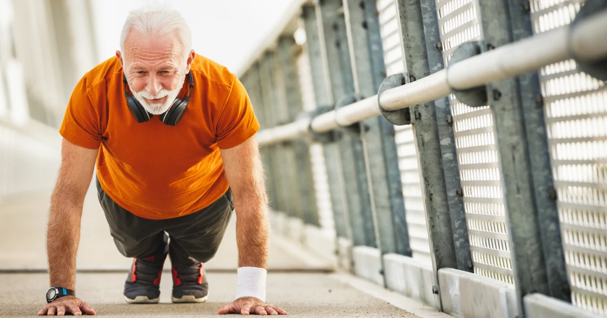 An older man exercising on an outdoor track