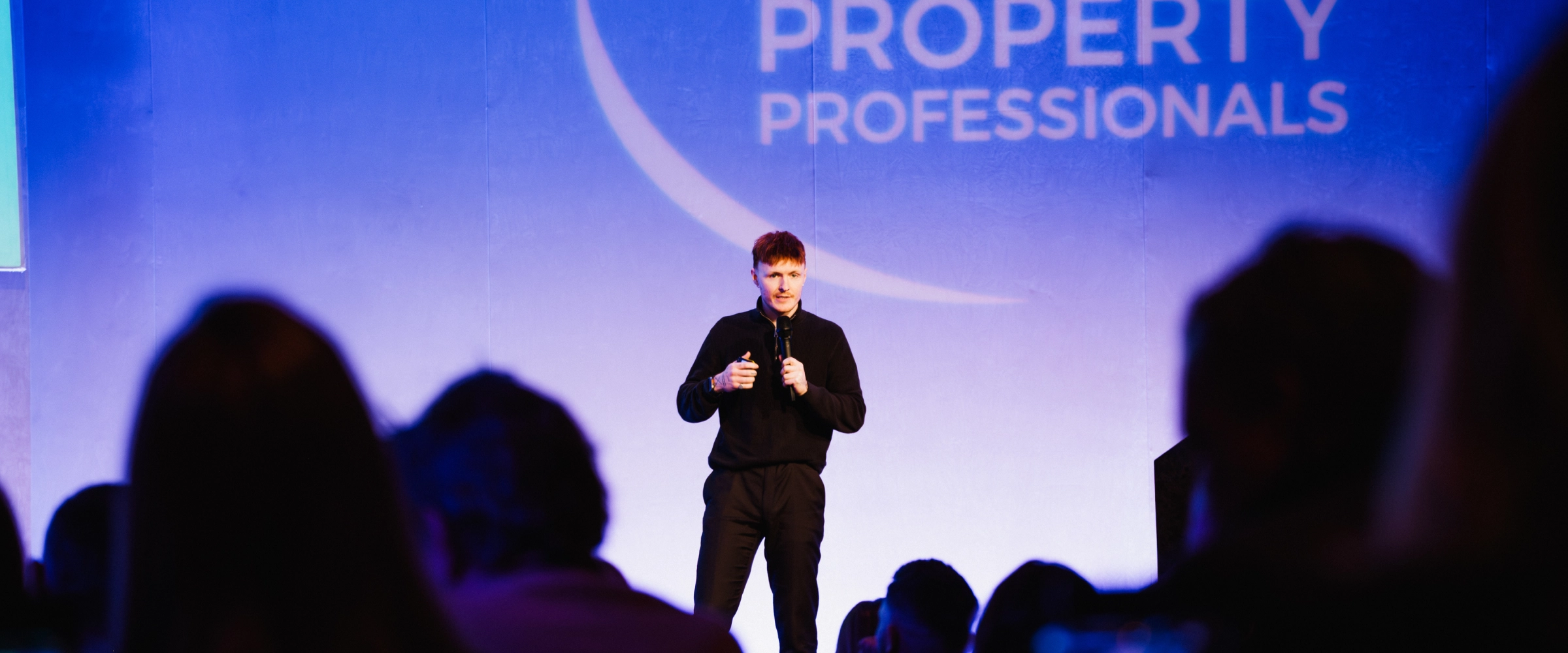 Calvin speaking on stage at Guild Conference 2026