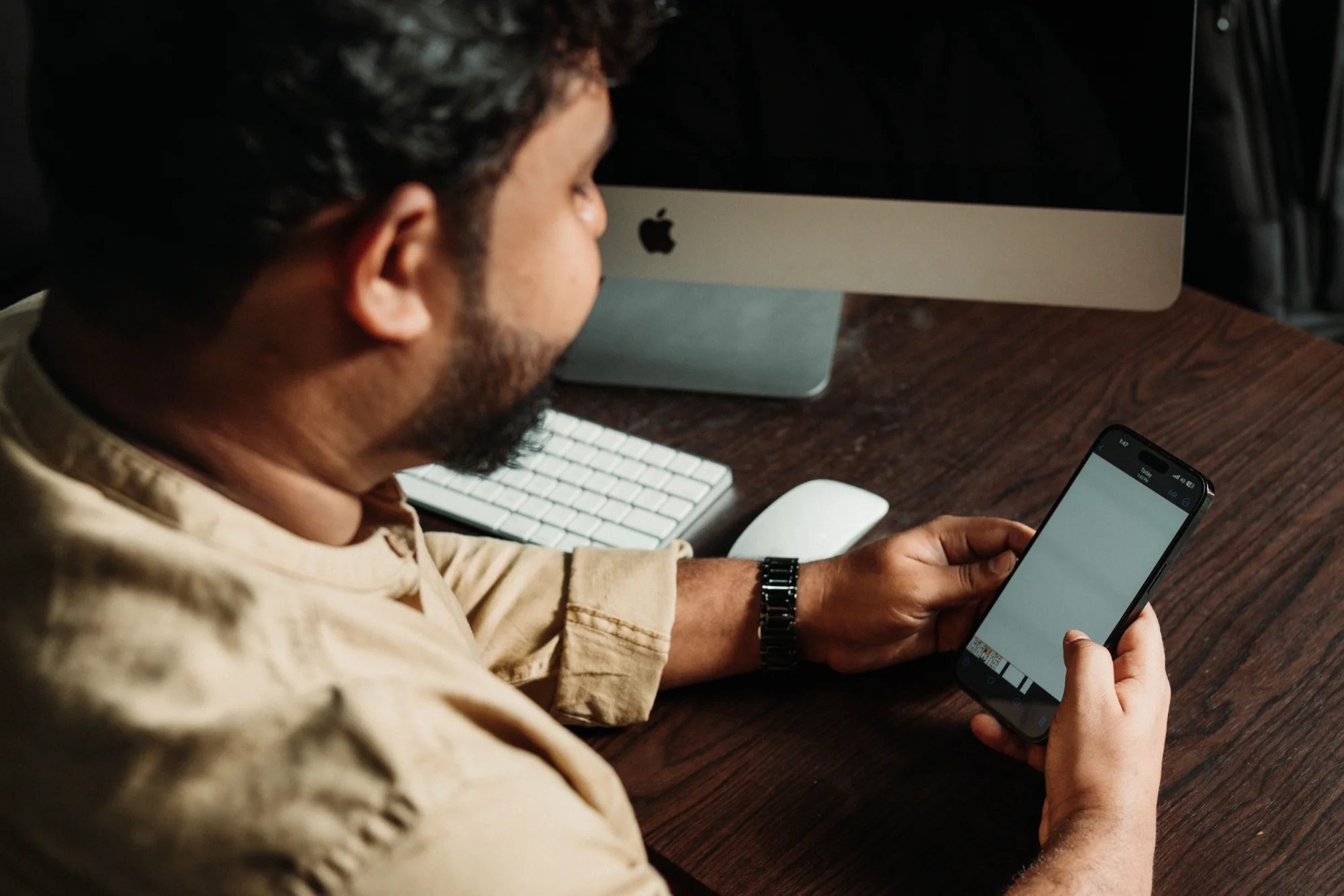 A care professional smiling while completing a structured interview on a mobile phone