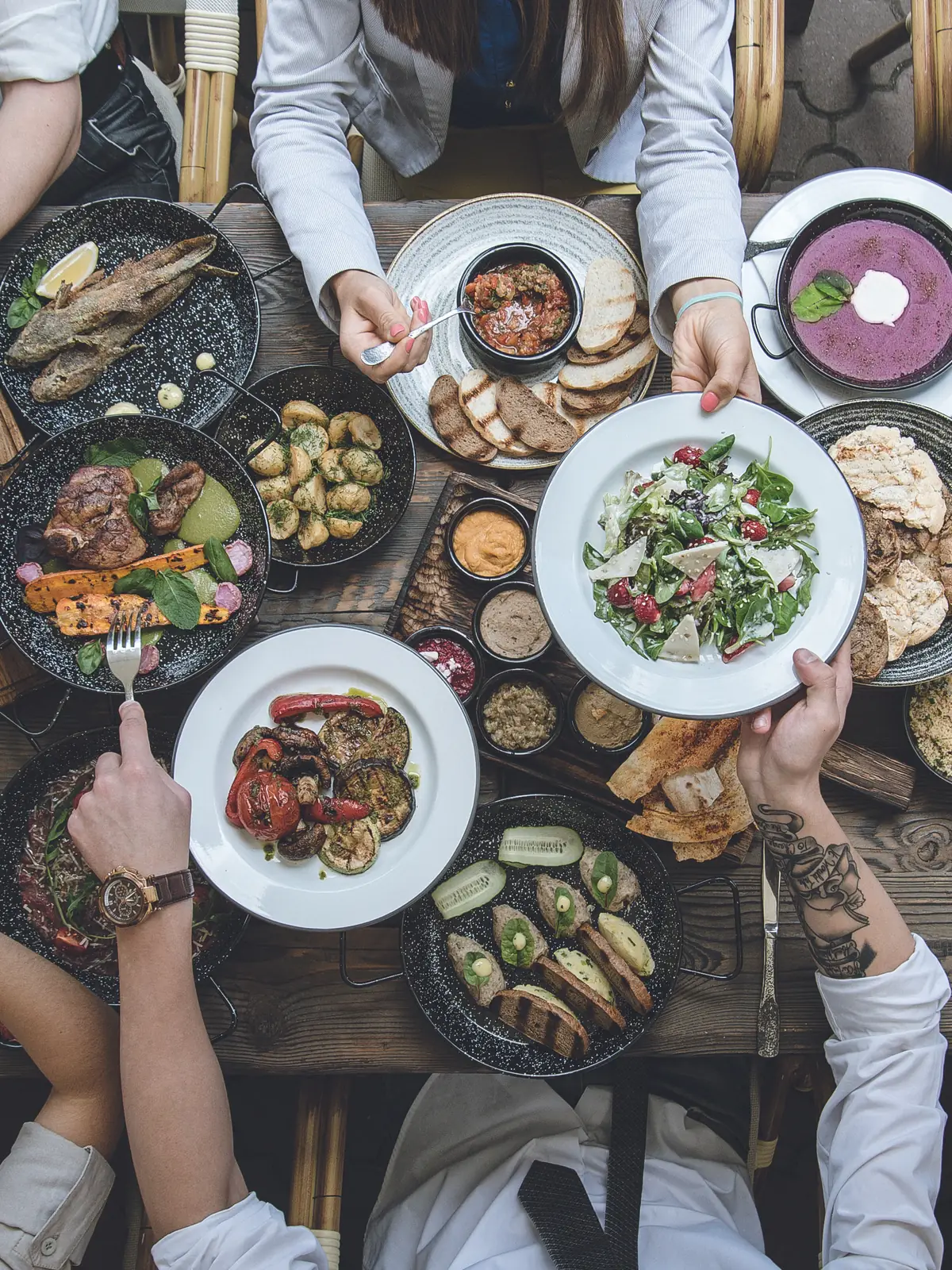 A shared table of dishes seen from above