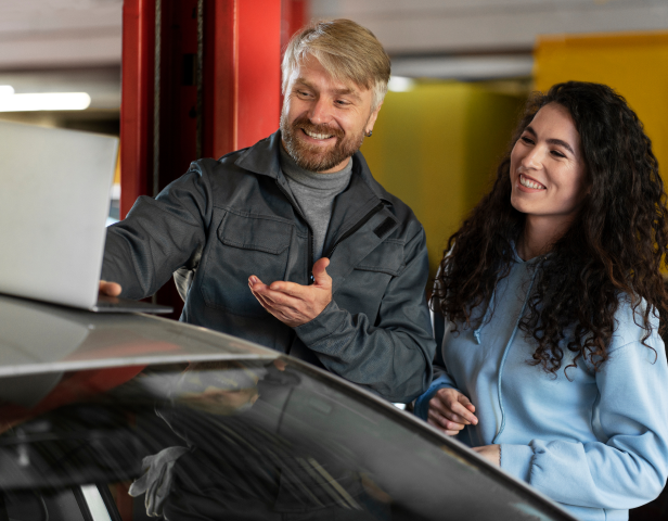 Employees smiling while checking car parameters