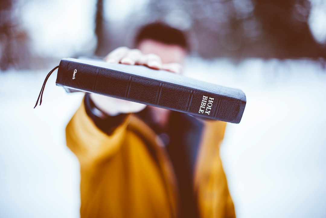 Person holding a Holy Bible