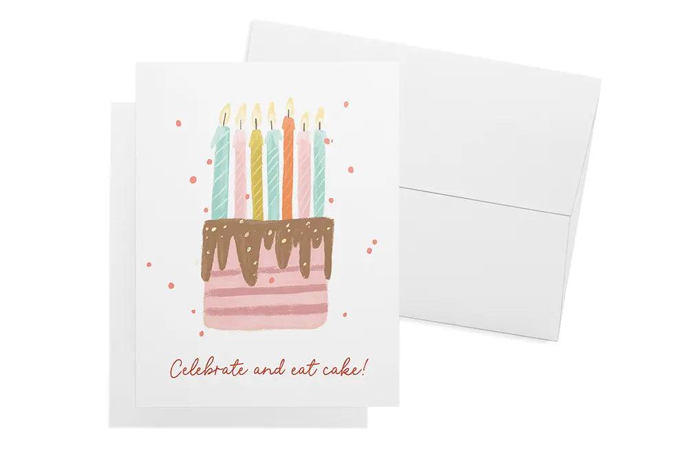 Birthday card with a cake and candles next to its envelope