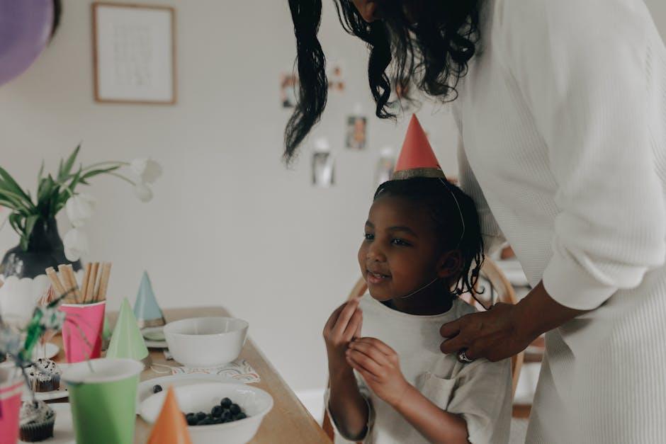 A girl in a party hat at her birthday party