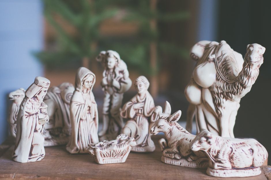 White ceramic nativity scene figures on a wooden table