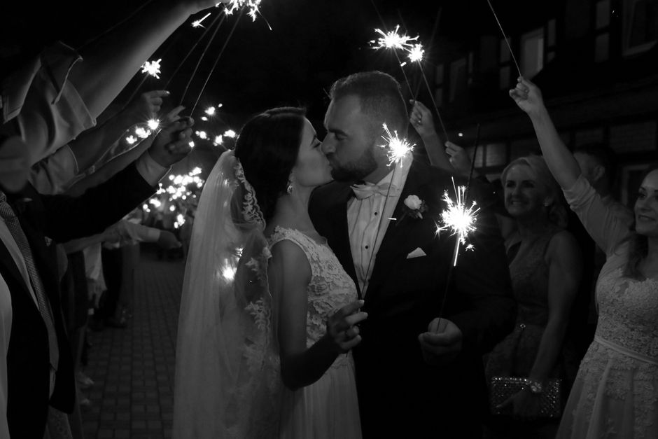 Couple kissing under sparklers