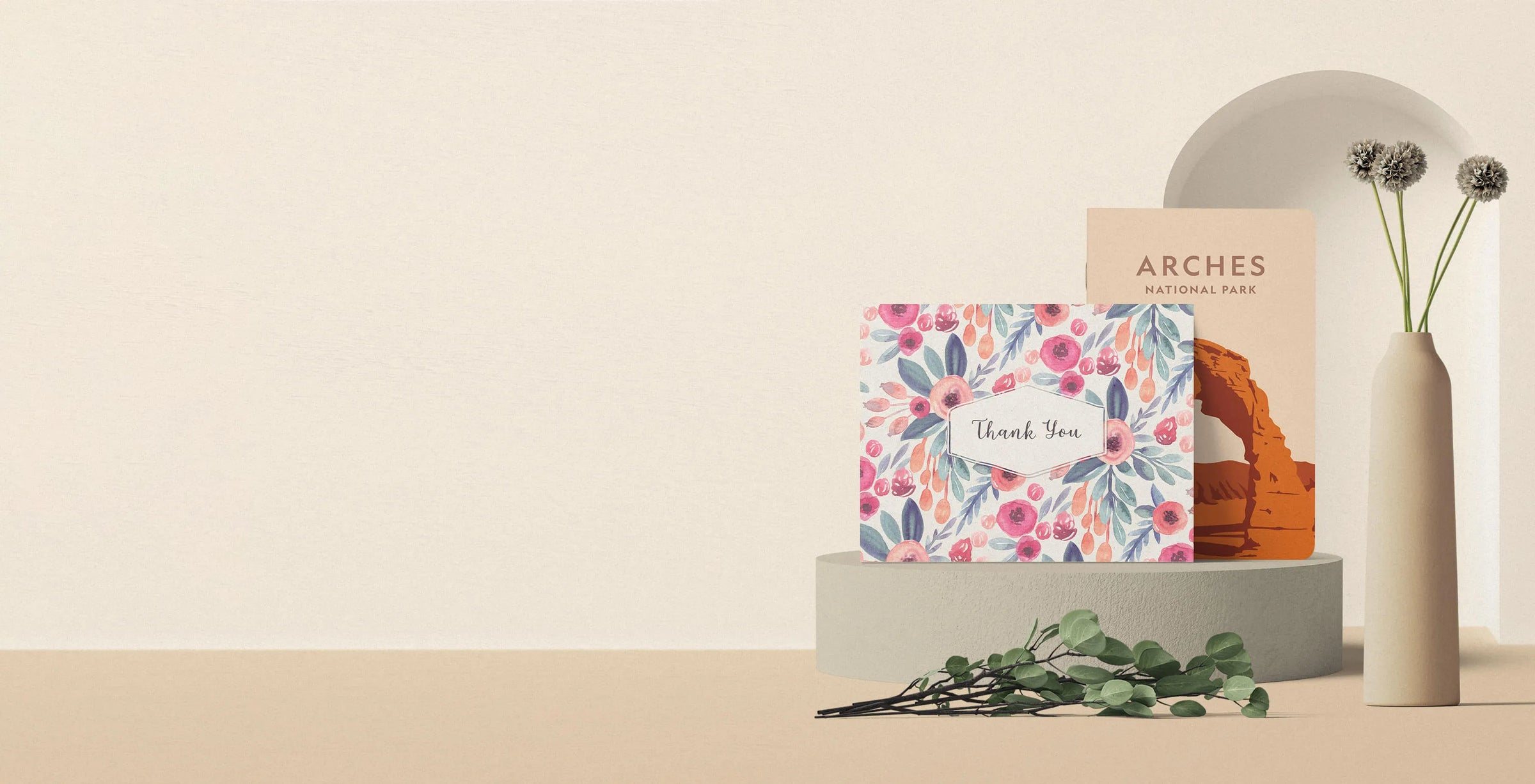 Greeting cards displayed on a shelf beside a vase