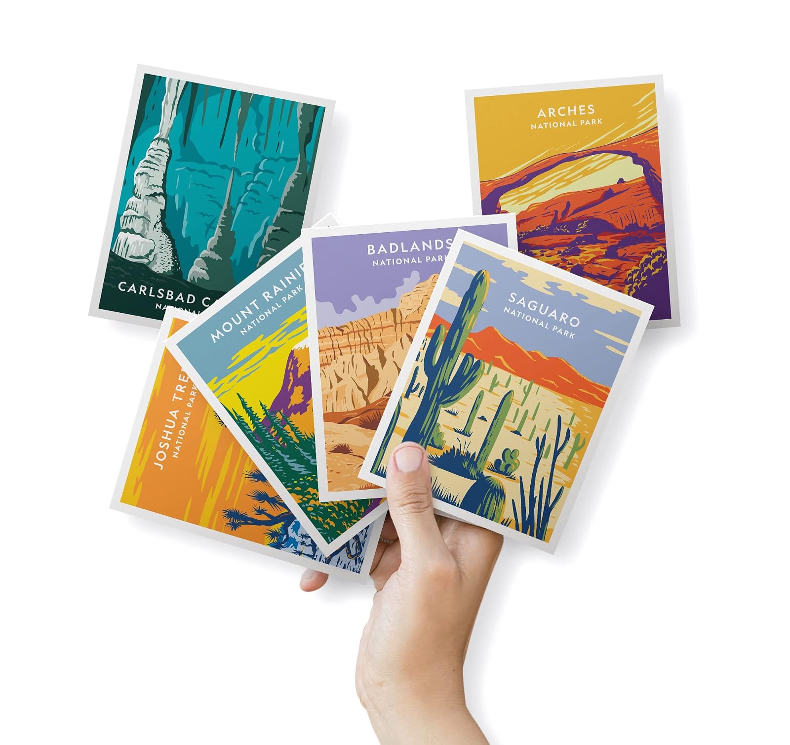 Hand holding a fan of national park greeting cards