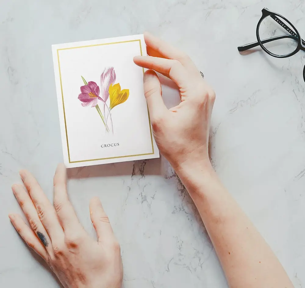 Botanical flower note cards on a desk