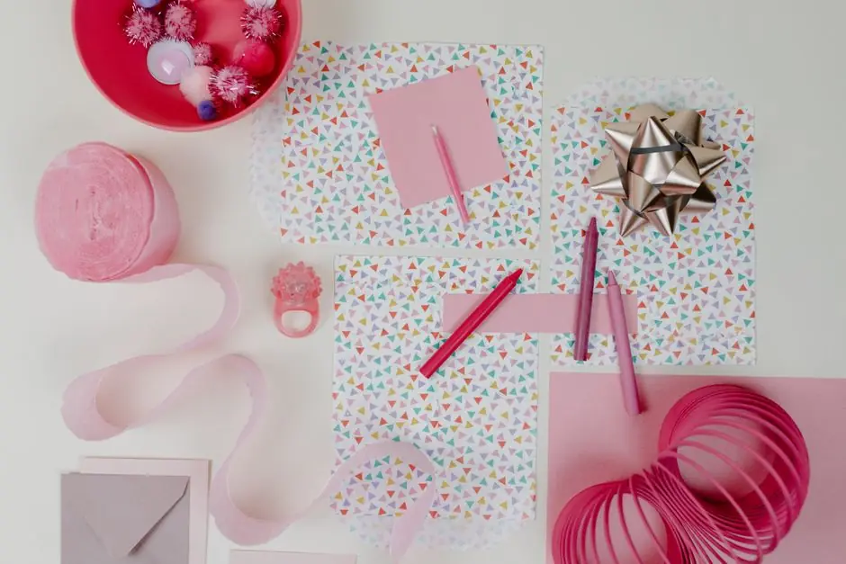 Gift wrap, ribbon and a card on a table