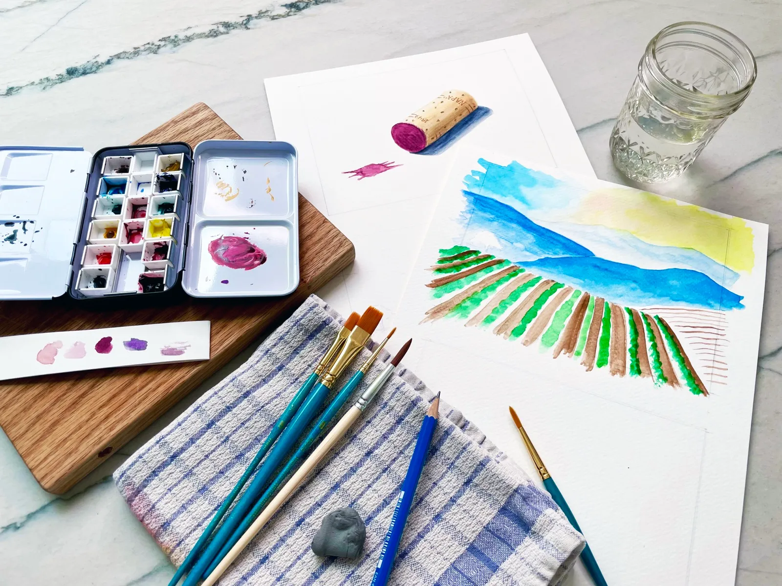 Watercolor class materials laid out on a table.